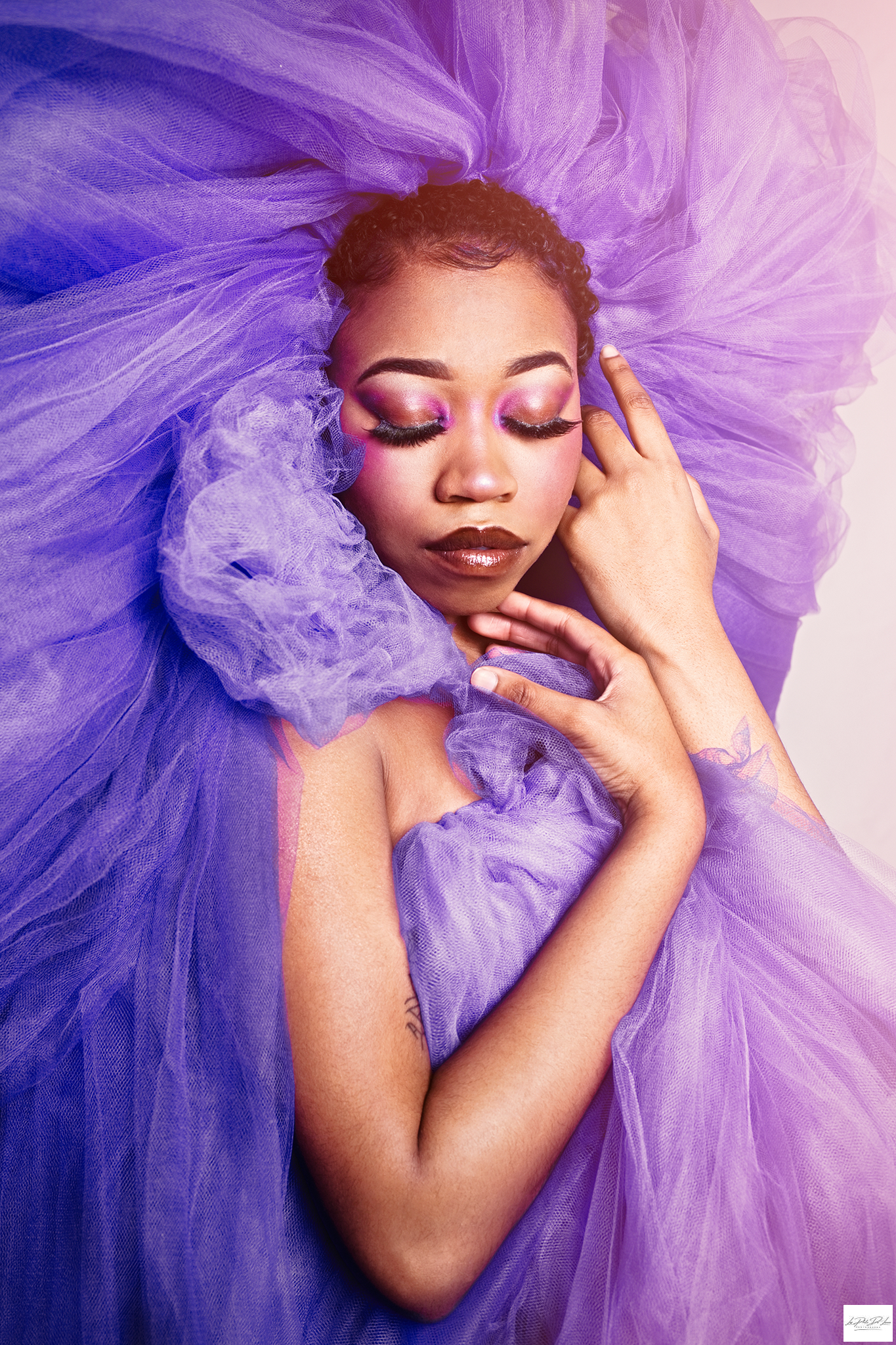 Black girl posing in purple makeup and tulle from head to toes