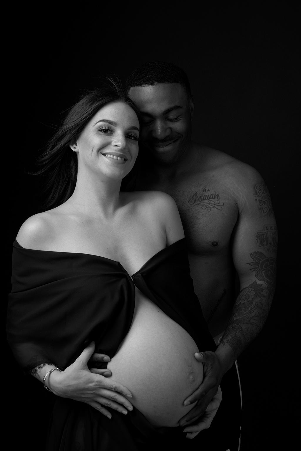 Mixed couple posing together in their maternity session