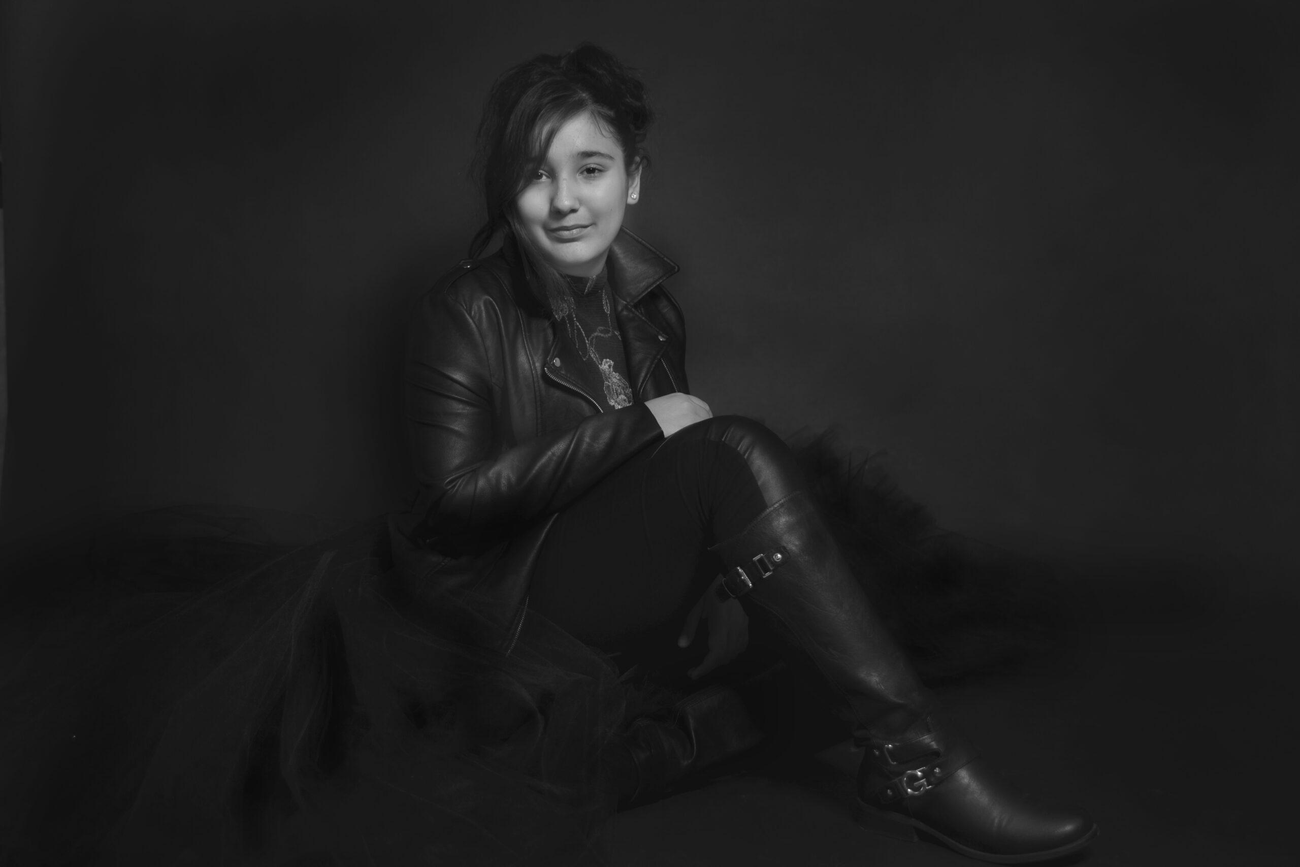 Teenager in boots posing for her black and white portrait